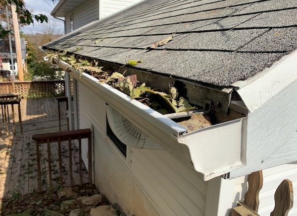 Gutter with leaves that needs to be cleaned out